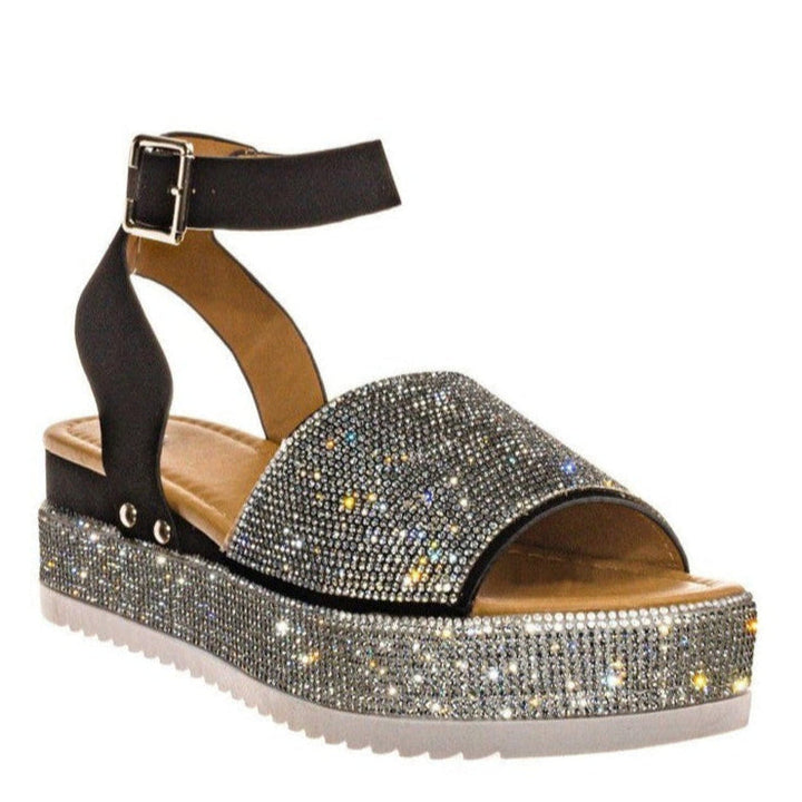 Stylish women's platform sandals featuring crystal rhinestone ankle straps and open-toe design for dressy occasions.