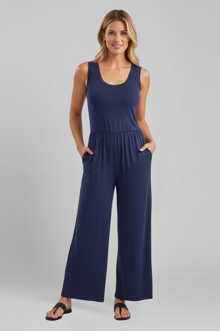 Stylish woman in a navy round neck wide leg jumpsuit with elastic waist, posing casually outdoors