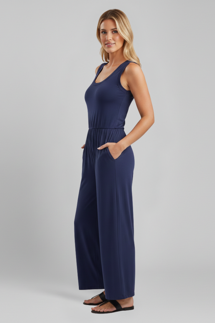 Back view of a woman wearing a casual green round neck wide leg jumpsuit, perfect for summer