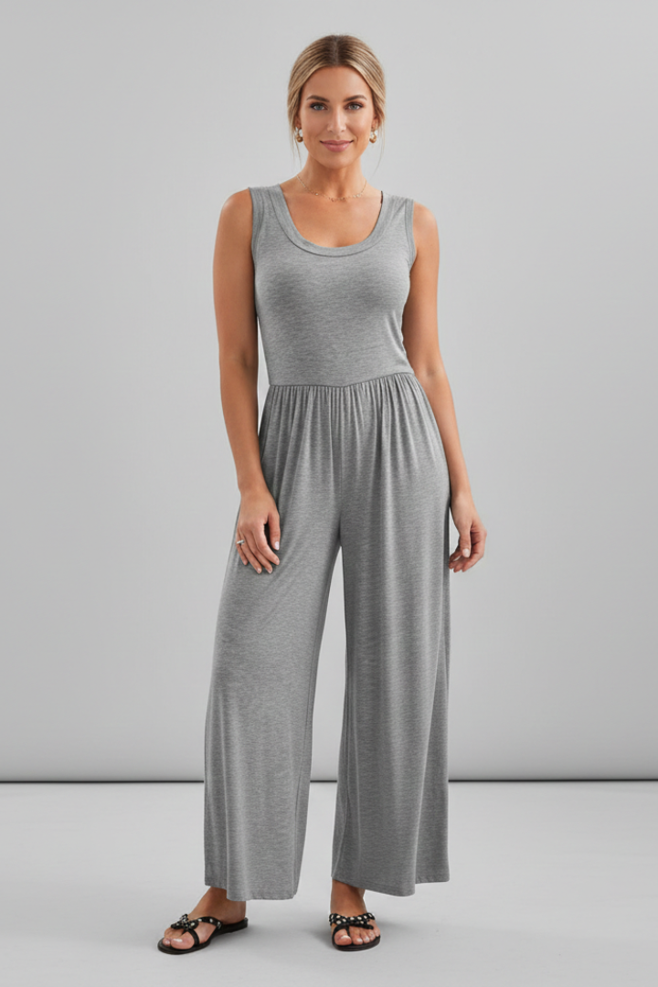 Full-body shot of a woman in a blue round neck wide leg jumpsuit, showcasing its casual fashion appeal