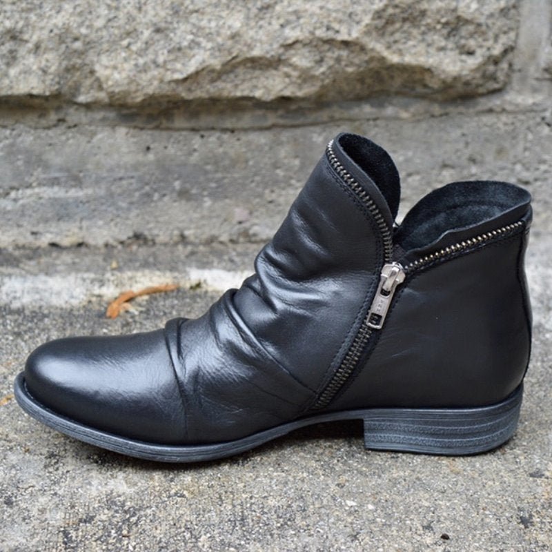 Women's black ruched leather ankle boots with side zipper, perfect for fall fashion.