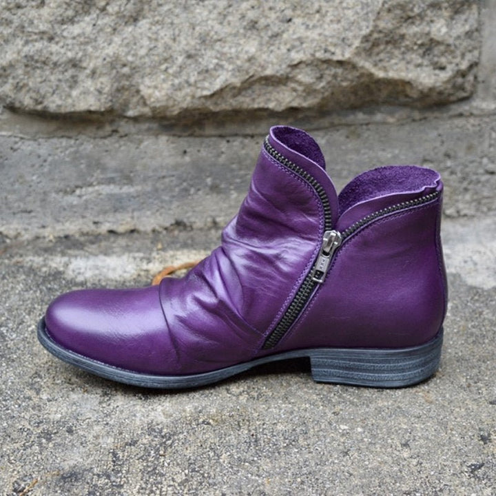 Fashionable women's ankle boots: black ruched leather with practical decorative side zipper.