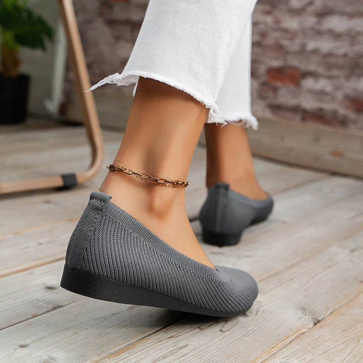 Women's black orthopedic slip-on comfort footwear, with athletic style and a flexible rubber sole.