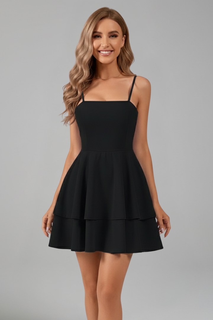 Close-up of fabric on women's spaghetti strap flared mini dress, showcasing texture