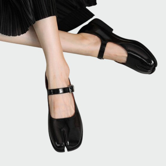 Fashionable black split-toe Mary Jane buckle shoes, showcasing their unique outline from a side angle.
