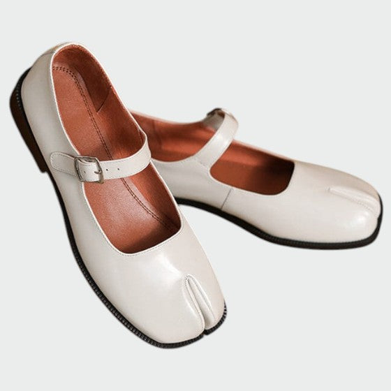 Side view of women's black split-toe buckle Mary Jane shoes, emphasizing the block heel's height.