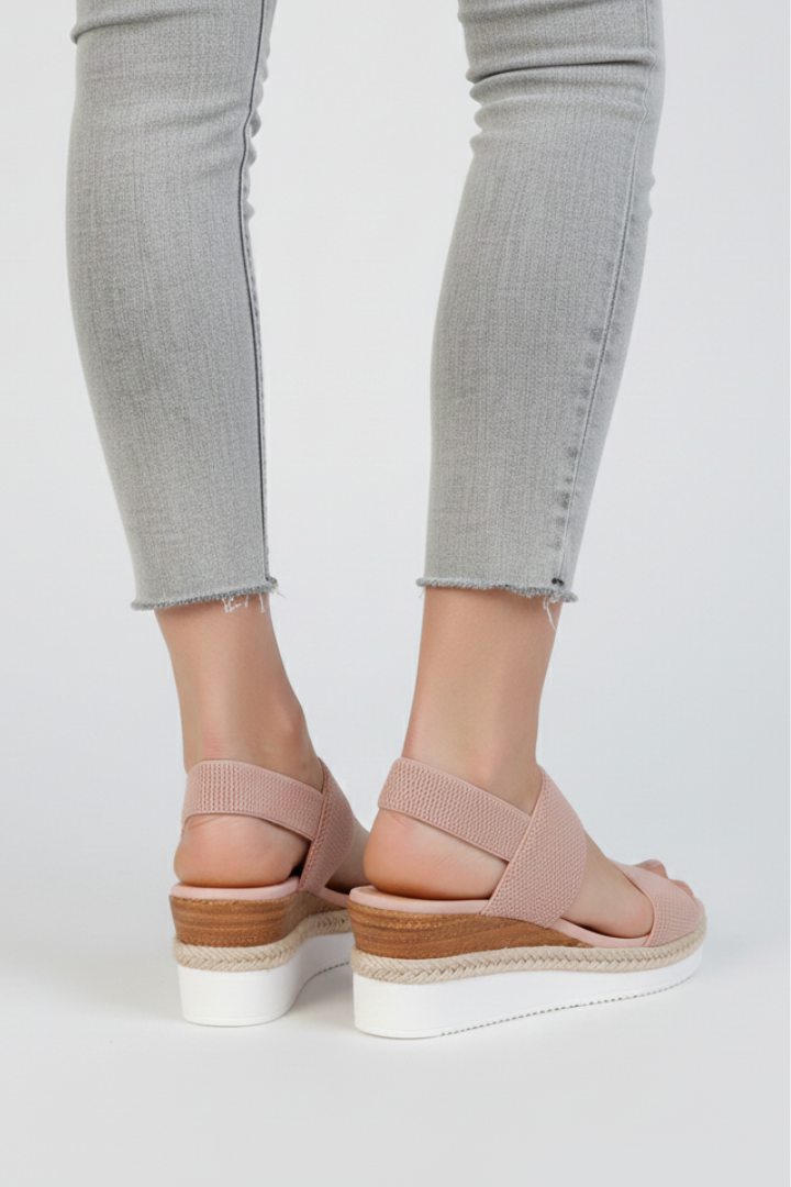 Pair of women's slip-on stretch sandals in a neutral tone, ideal for casual everyday wear.