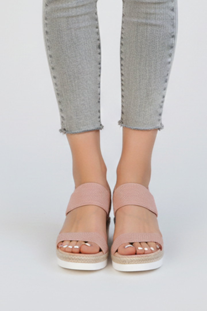 Side view of women's raised sole sandals, highlighting the comfortable stretch fabric design.