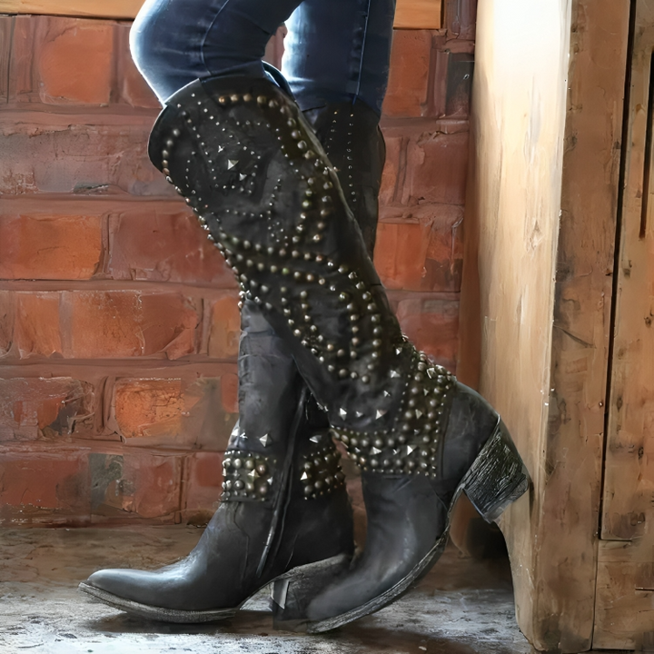 Close-up of women's studded cowboy boots, showcasing the detailed stud work and classic Western design.