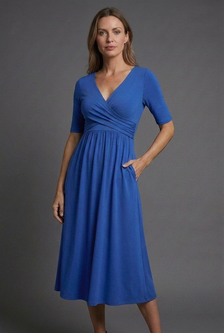 Flattering black V-neck wrap midi dress for women with short sleeves & convenient pockets, ideal for summer style.