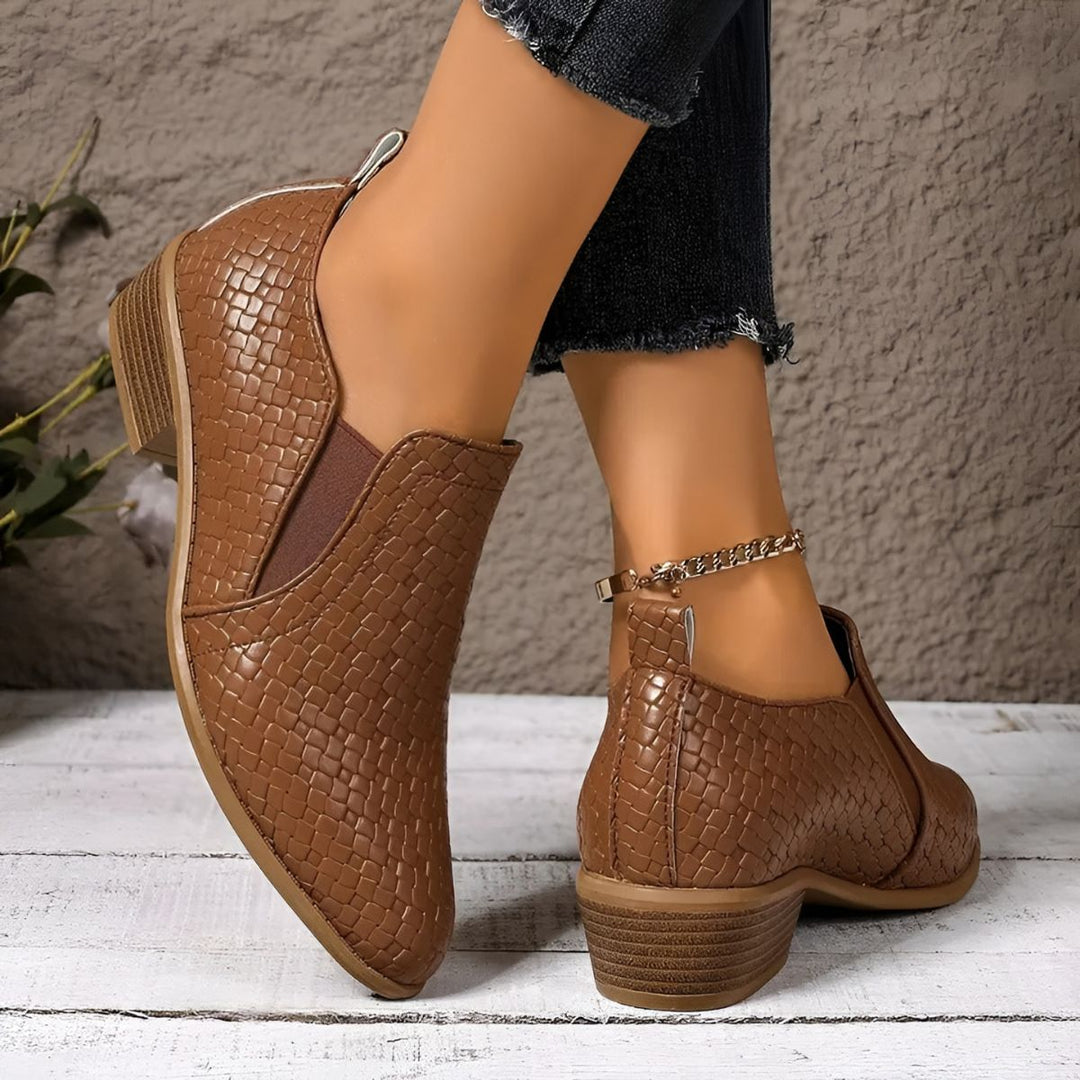 Classic black oxford flats for women, highlighting their versatile appeal as work or casual footwear.