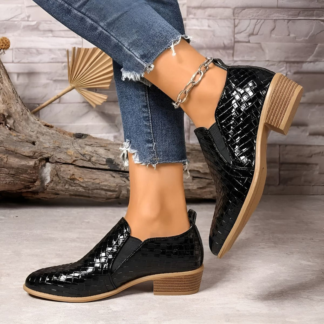 Pair of classic black oxford flats for women, made from comfortable vegan leather, ideal for work.