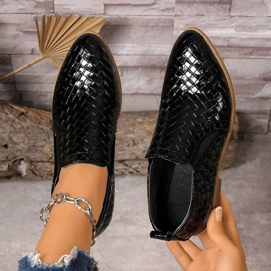 Woman walking in classic black vegan leather oxford shoes, suitable for casual and formal outfits.