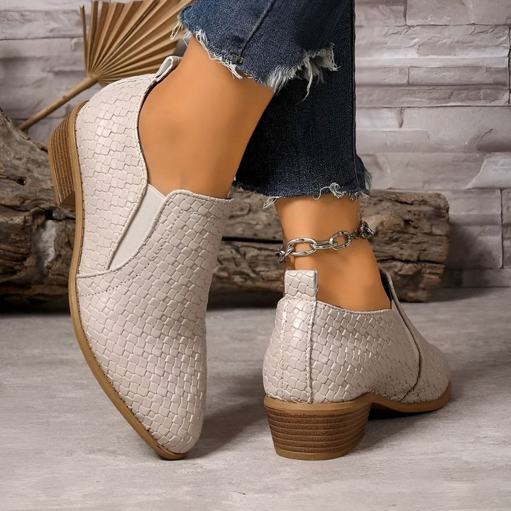 Front view of a pair of women's black oxford flats, emphasizing their sleek and comfortable design.