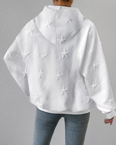 Close-up of embossed star detail on women's grey zip-up relaxed fit hoodie for loungewear fashion.