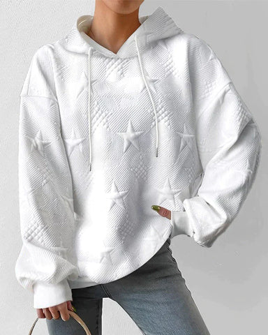 Side profile of woman wearing a relaxed fit zip-up hoodie with embossed stars, perfect for casual style.