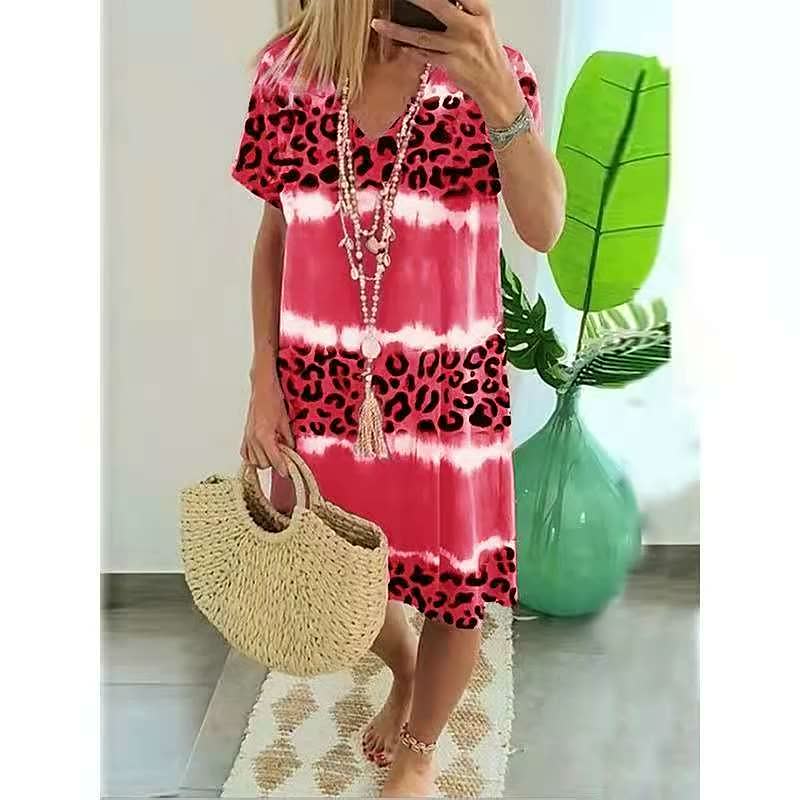 Stylish women's short-sleeve V-neck shift dress in a bold print. Ideal for casual summer outfits.