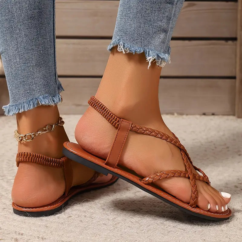 Top view of women's braided flat sandals, highlighting the simple casual design