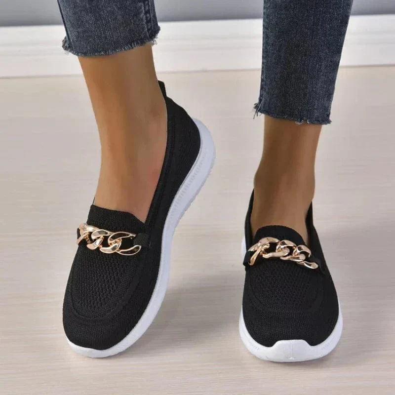 Pair of women's gray mesh shoes, offering breathability and foot support for casual wear