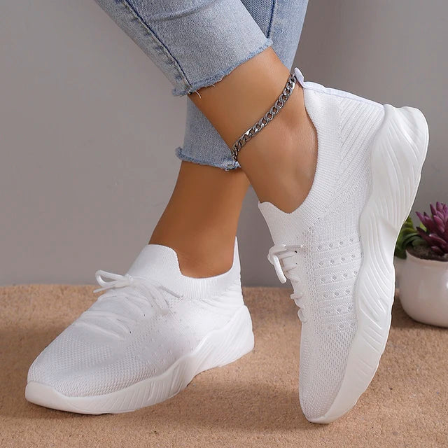 Black stylish slip-on women's sneakers, designed for breathable comfort & everyday wear.