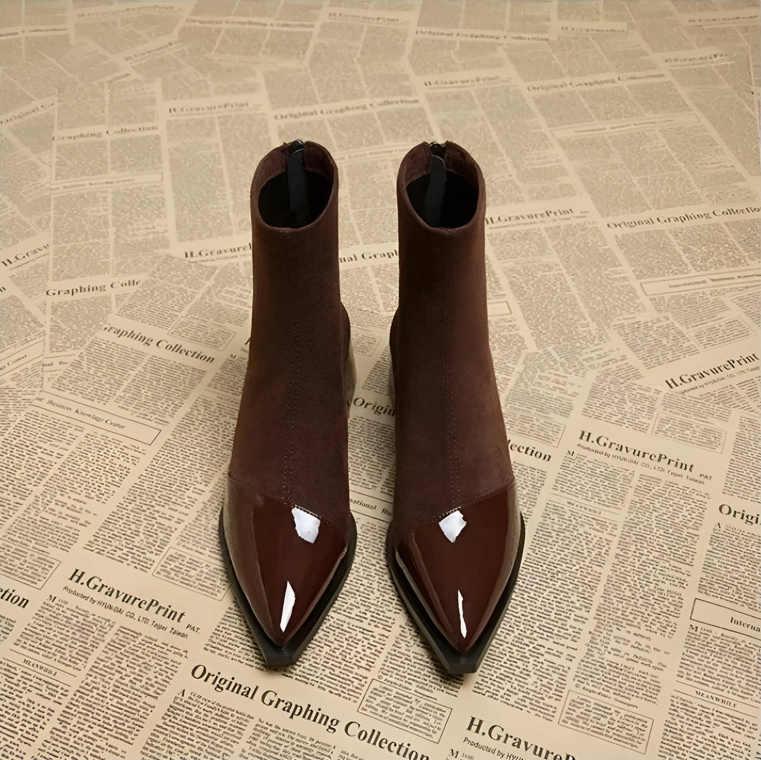 Pair of black women's block heel ankle boots, essential comfortable winter footwear.