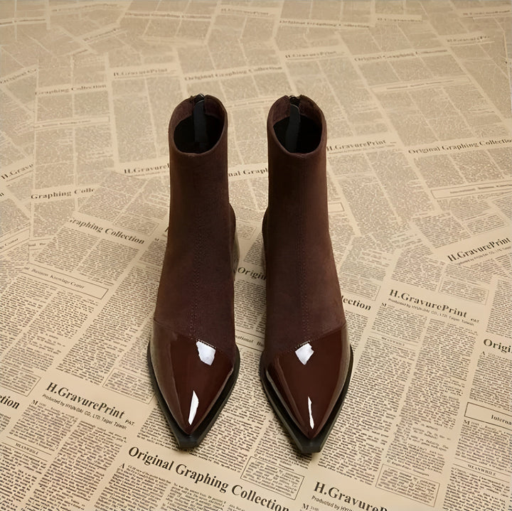 Pair of black women's block heel ankle boots, essential comfortable winter footwear.