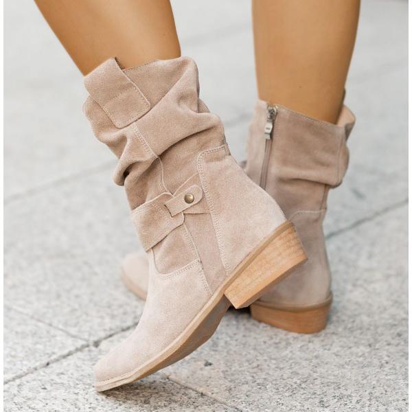 Closeup of women's comfortable suede Western ankle boots with zipper detail.