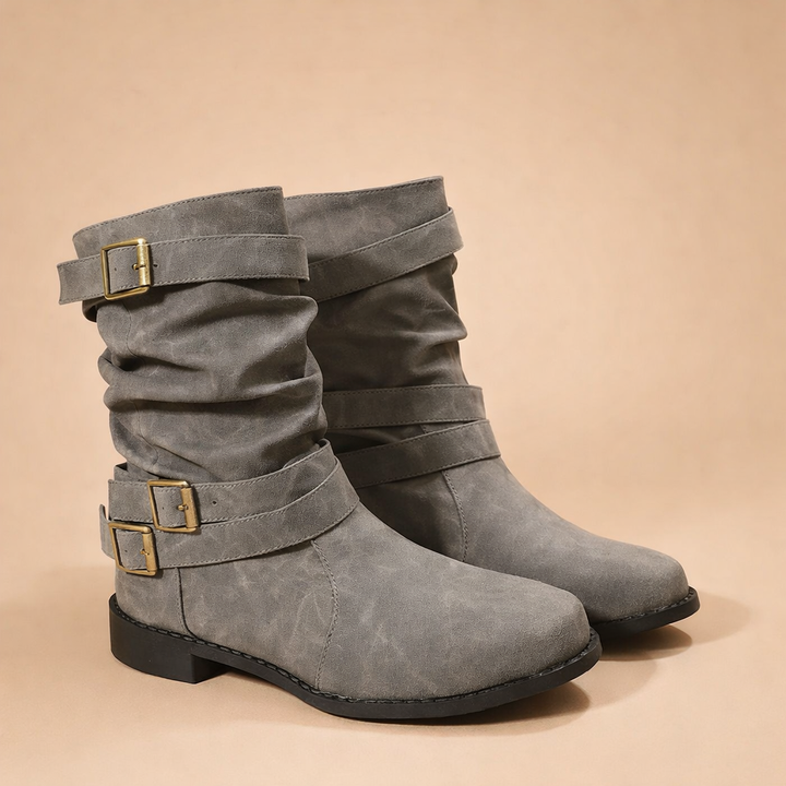 Women's mid-calf boots featuring decorative buckles & straps. Versatile winter fashion boots for women.