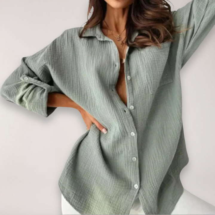 Relaxed fit women's summer top featuring stylish roll-up sleeves and a classic button front.