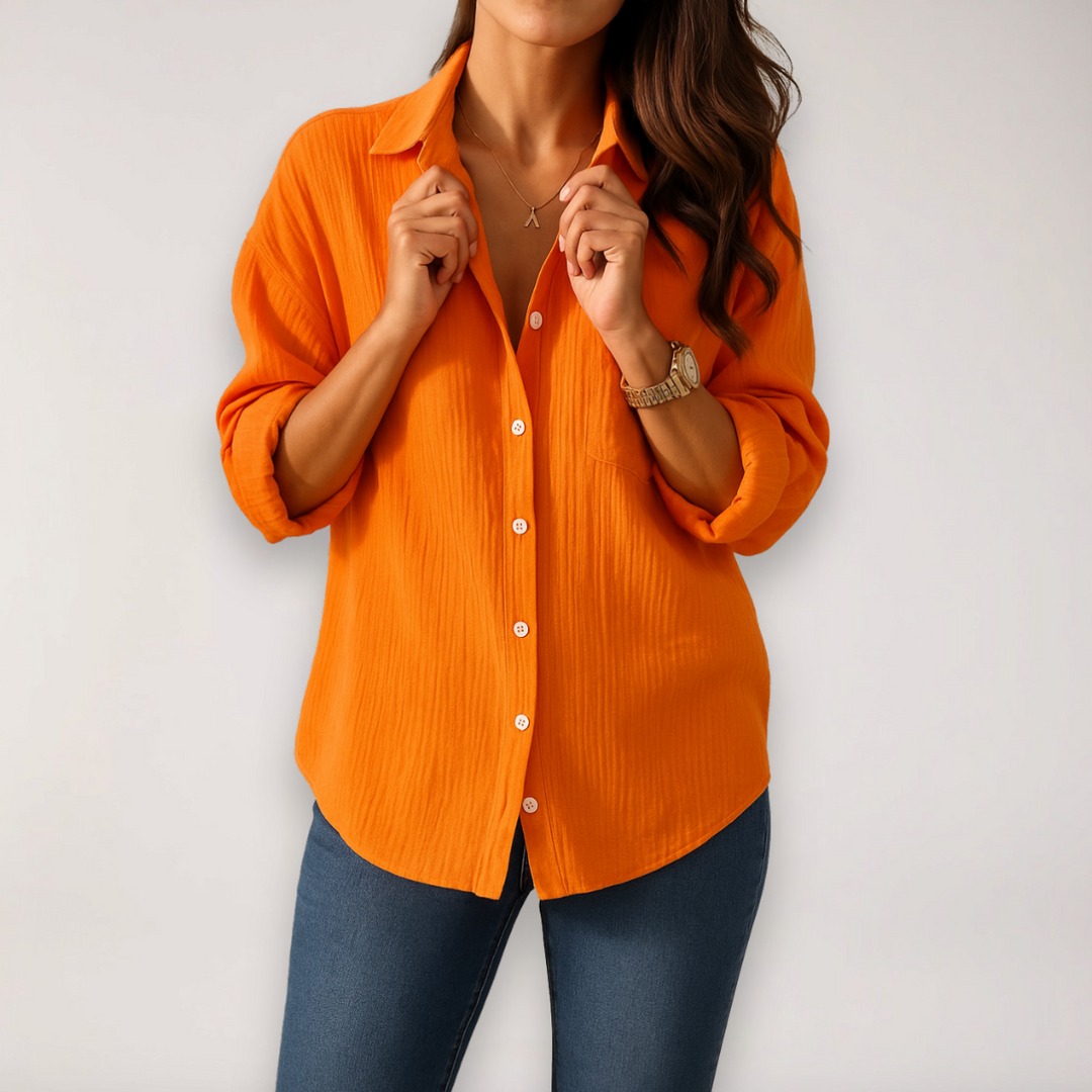 Lightweight versatile women's blouse with button front and adjustable roll-up sleeves.