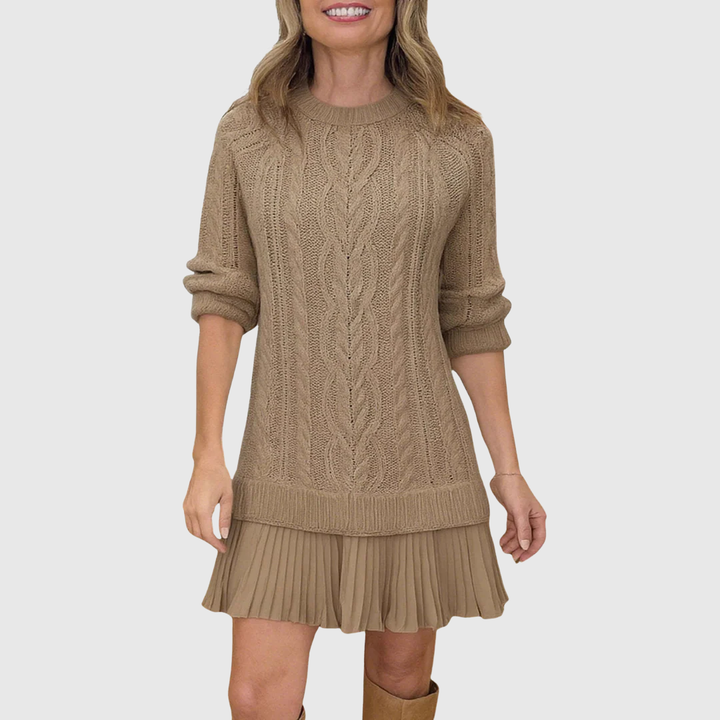 Women's cable knit sweater dress with pleated hem, elegant autumn winter knitwear.