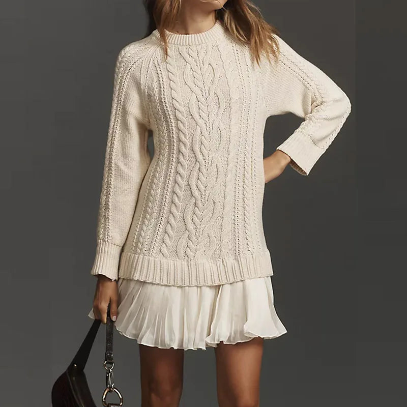 Elegant women's knit sweater dress with a flowing pleated bottom, ideal for winter.