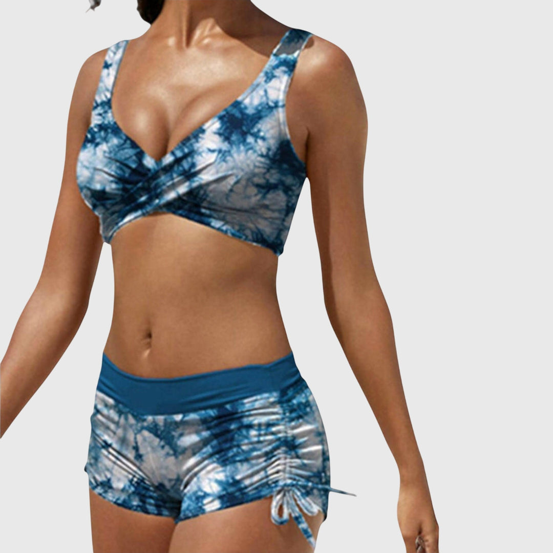 Female model in a trendy camouflage print two-piece bikini swimsuit for resortwear