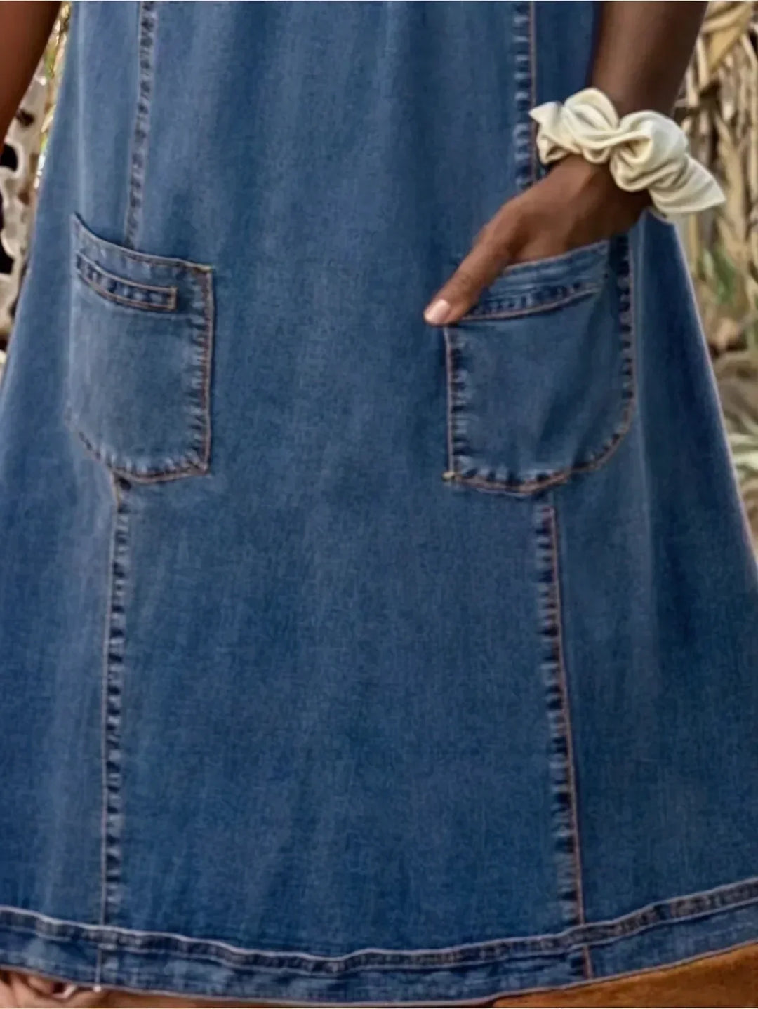 Woman wearing a comfortable blue A-line pocket summer dress, front view