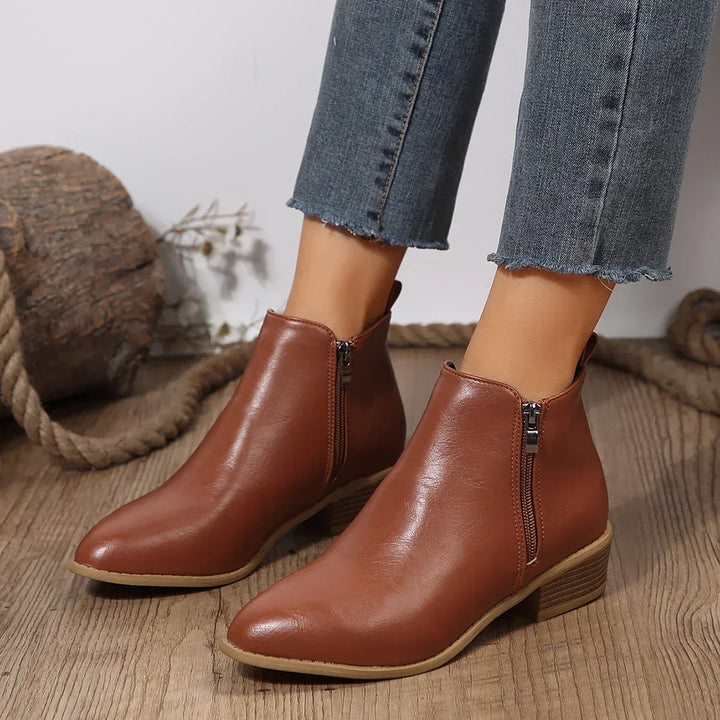 Close-up of the side zipper detail on women's casual ankle boots, highlighting quality and style.