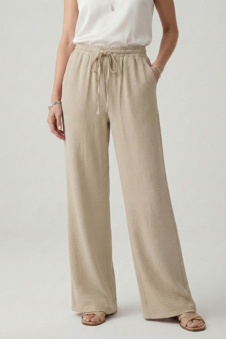 Full-length view of women's flowy palazzo trousers, ideal for casual and relaxed wear with drawstring.