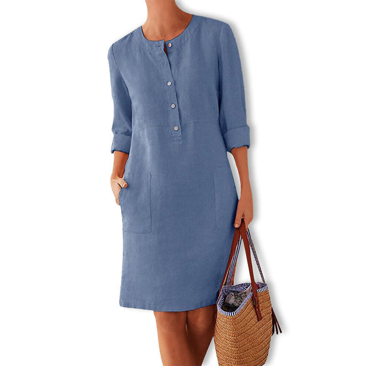 Women's casual button front summer dress with practical pockets, perfect for beach or vacation wear.