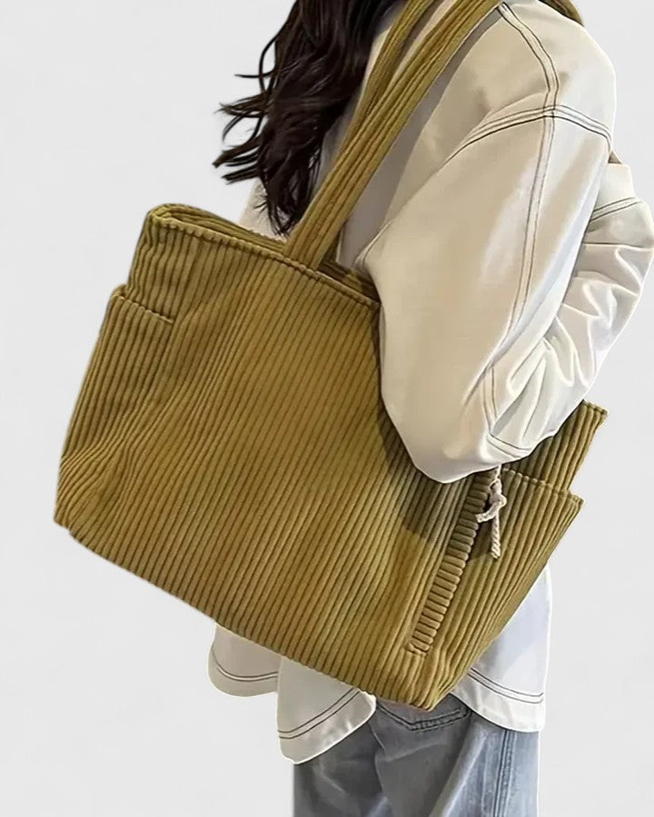 Durable women's casual shoulder bag showcasing multiple compartments and sturdy zipper pulls