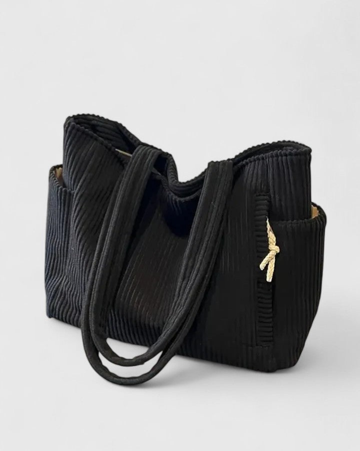 View of the back of the women's utility shoulder bag, featuring a discreet zippered pocket