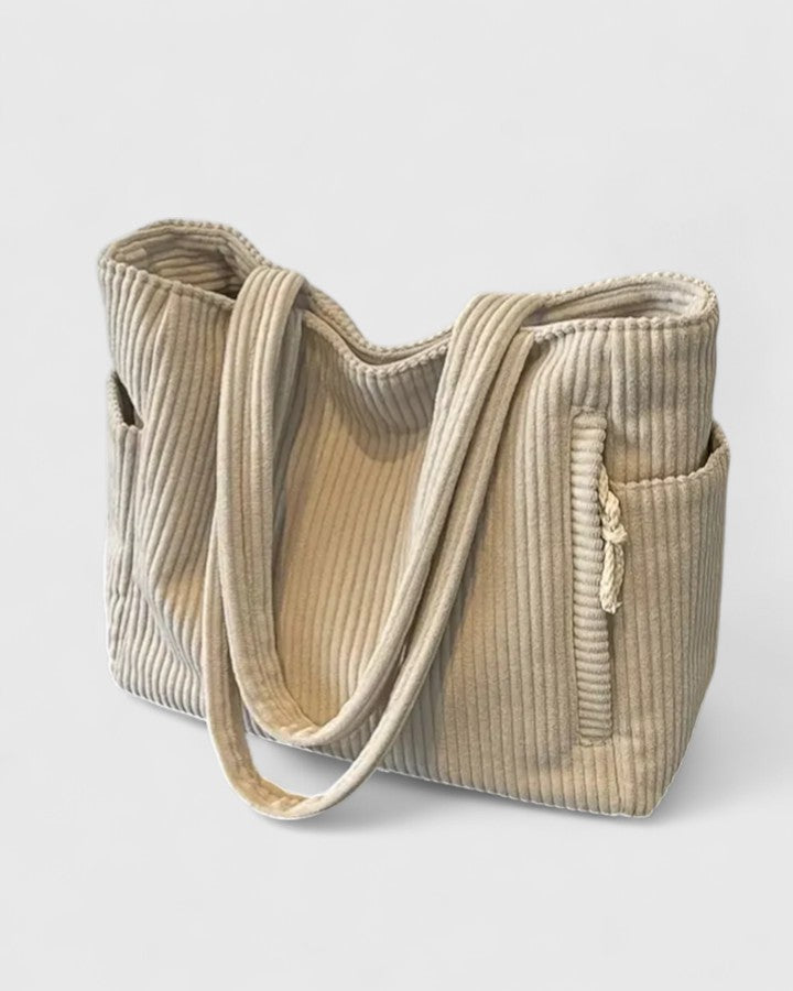 Fashionable women's utility messenger bag in neutral tone, ideal for travel and daily errands