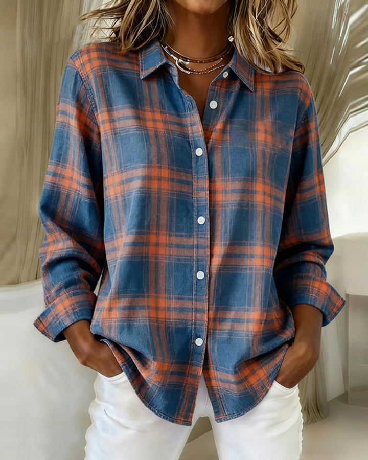 Close-up of a women's checked long sleeve shirt, highlighting the sophisticated notched lapel and fabric detail.
