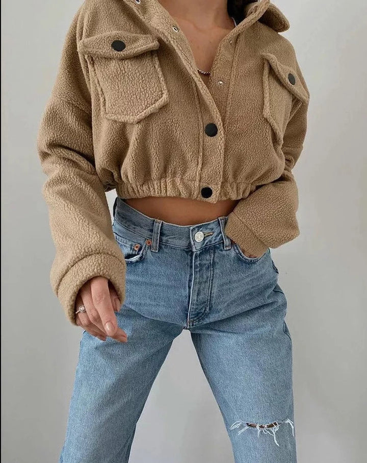 Fashionable women's cropped jacket with snap-up front, lightweight design, ideal for casual spring wear.