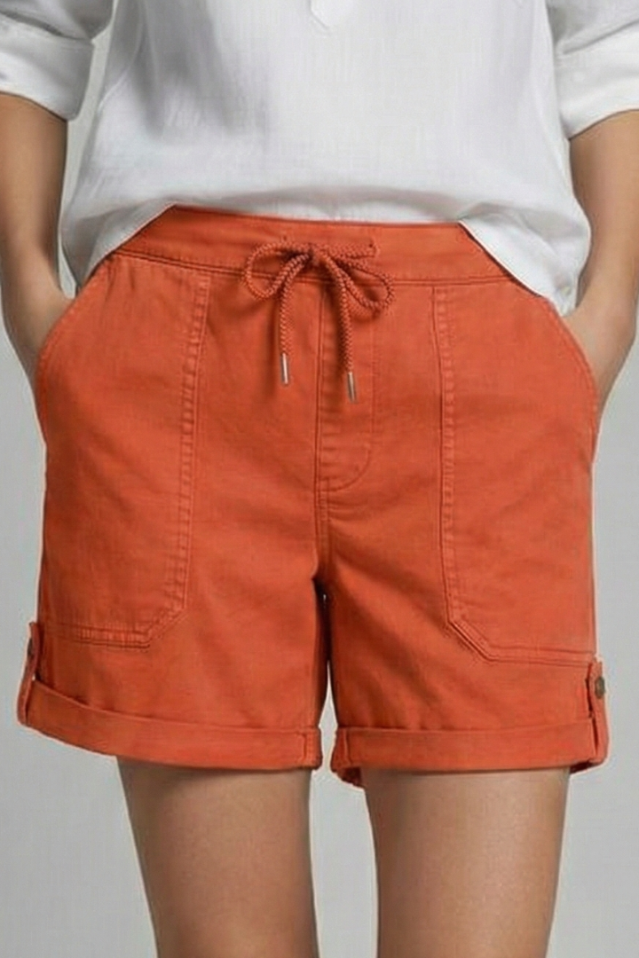 Close-up on a hand adjusting the drawstring of comfortable women's casual shorts.