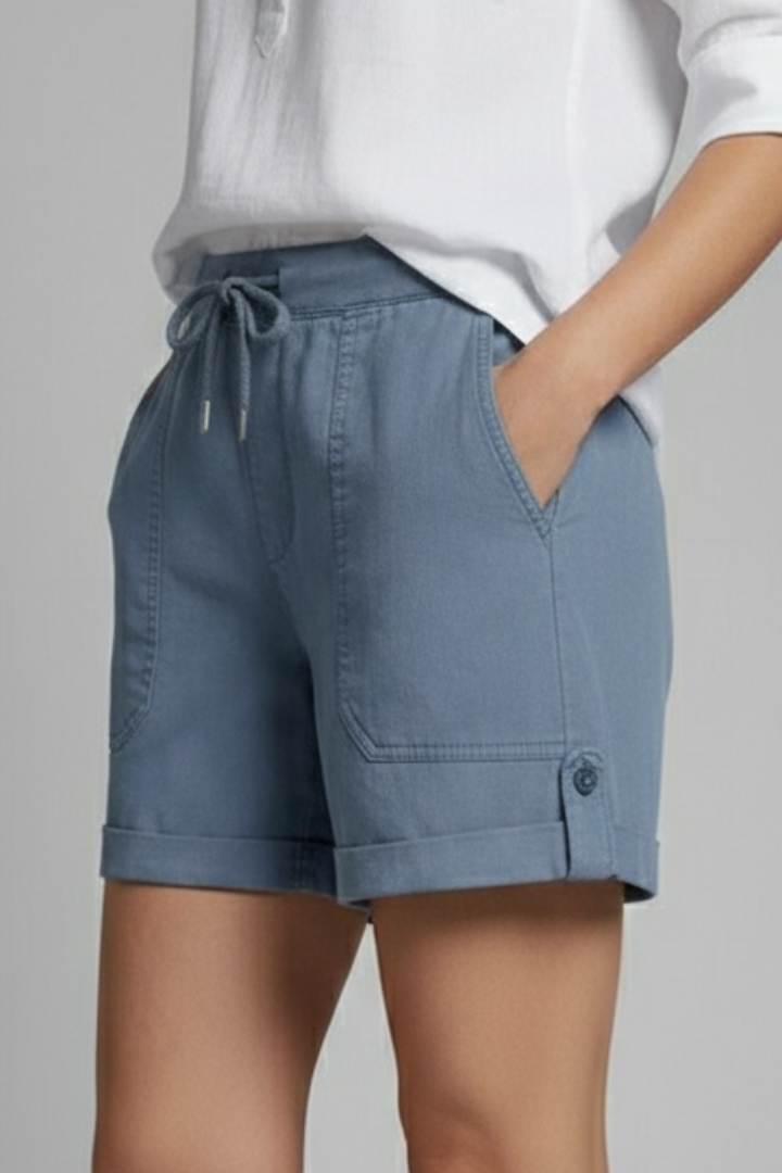 Woman wearing comfortable grey drawstring shorts, paired with a white t-shirt, casual summer outfit.