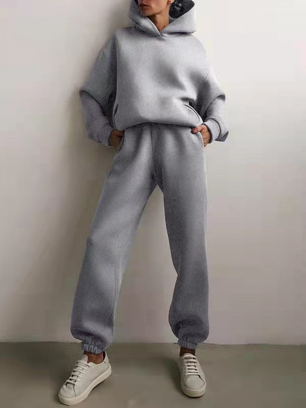 Soft women's two-piece hoodie & sweatpants set, perfect for comfy casual loungewear or athleisure activities.