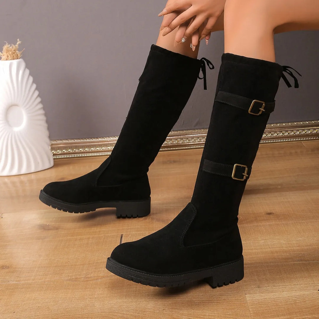Women's casual knee-high suede boots with buckle detail, perfect for winter fashion.
