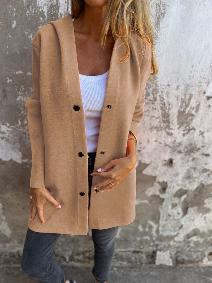 Close-up of the textured knit fabric on a women's hoodie jacket, showing button detail and soft material.