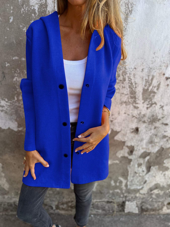 Soft knit women's jacket with hood and buttons, offering comfort and classic style for everyday wear.