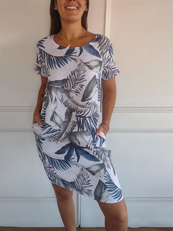 Flowy women's summer dress with vibrant leaf print and comfortable short sleeves, casual wear.