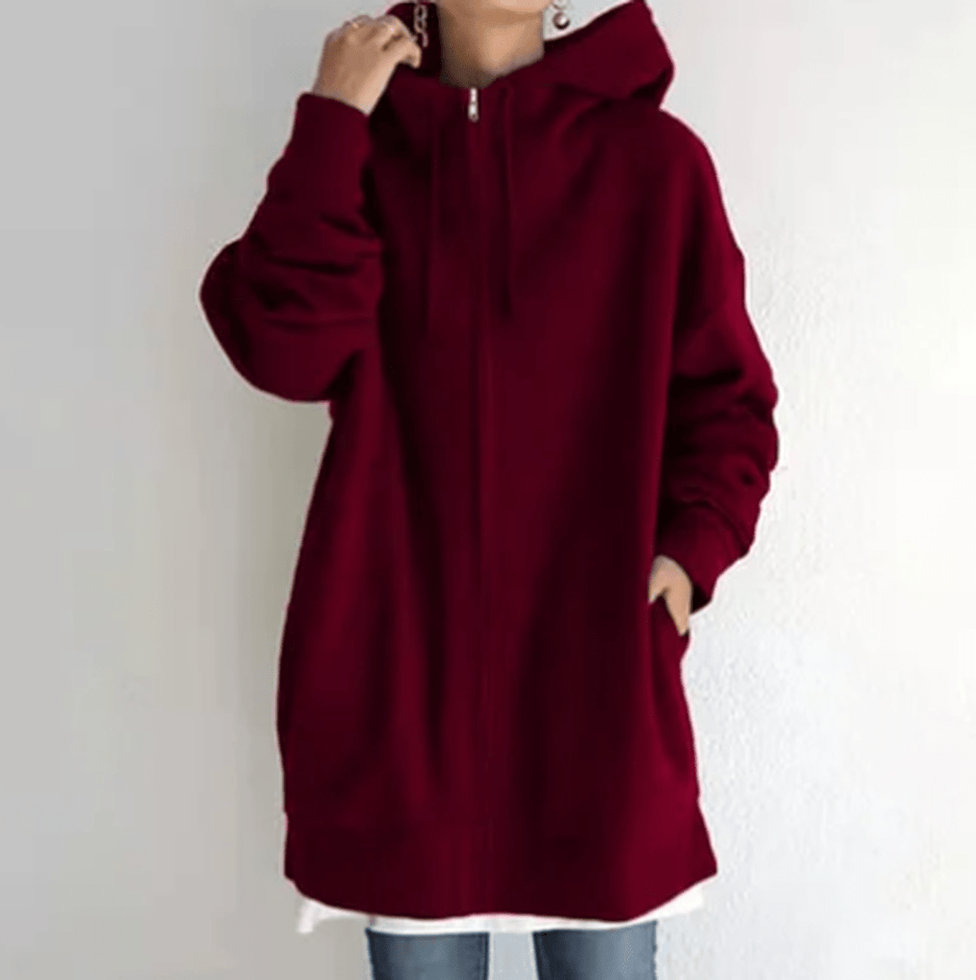 Lifestyle shot of a woman relaxing in a cozy long sleeve zip-up hoodie, ultimate loungewear